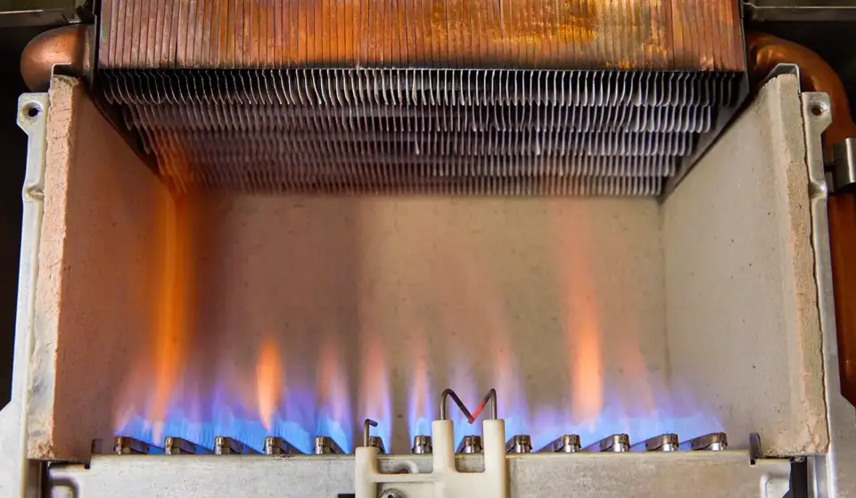 Gas burning in a heating appliance, where a stainless steel burner heats a copper heat exchanger.