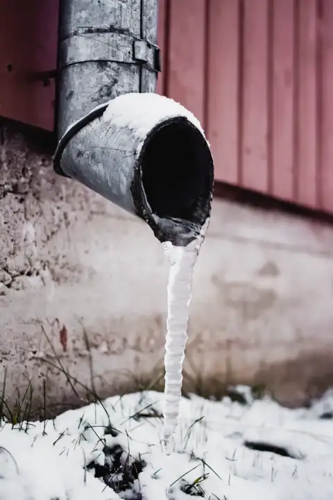 Frozen downspout in the middle of winter
