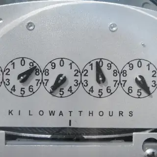 Closeup of an electric meter showing the kilowatt hours the household consumes.